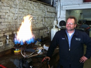 ETS Technician bench test firing a LP gas burner ring from a hot high pressure washer